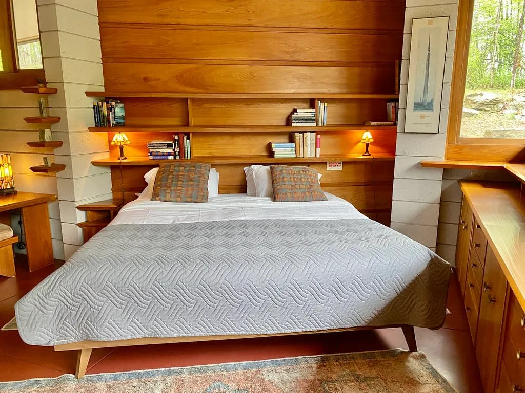 Bedroom with a wood-panelled wall behind the bed