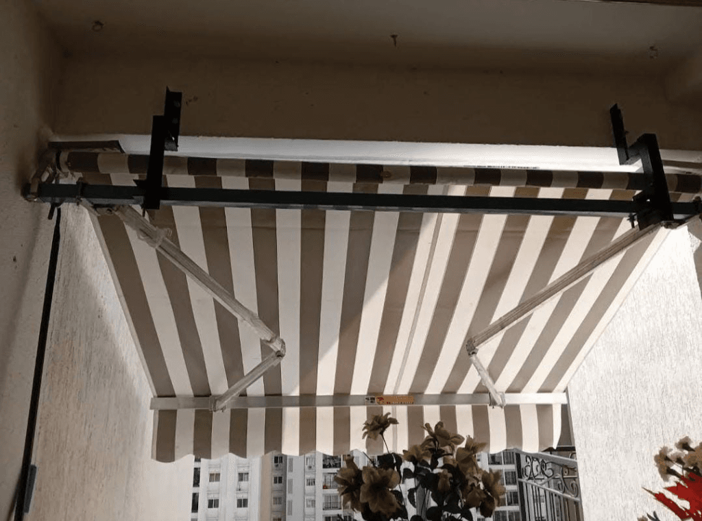 Custom Retractable Striped Balcony Awning with Ceiling Drop Brackets in Panjim, Goa
